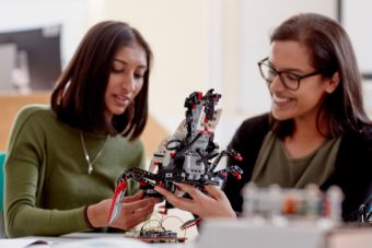 Two students using robotic equipment
