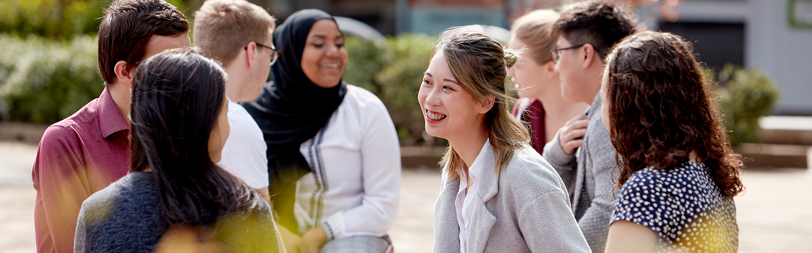 Students sitting outside and chatting