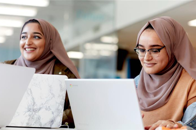 Two students studying on their laptops