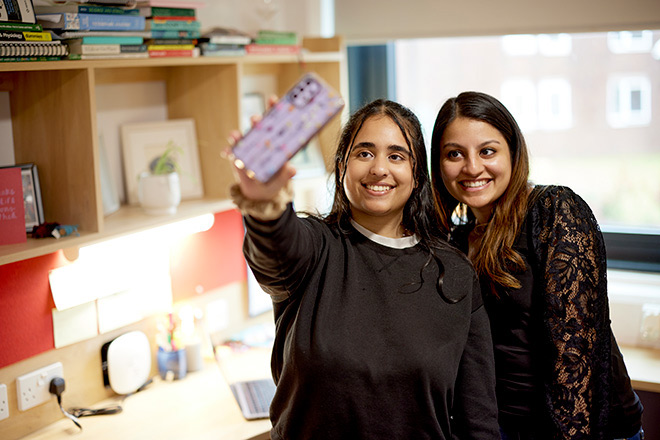 Two students taking a selfie in their accommodation
