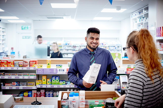 A pharmacist serving a customer