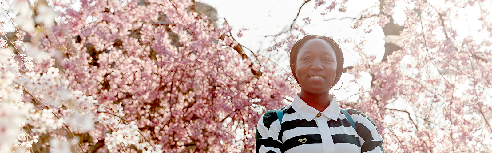 Female standing in-front of blossom tree