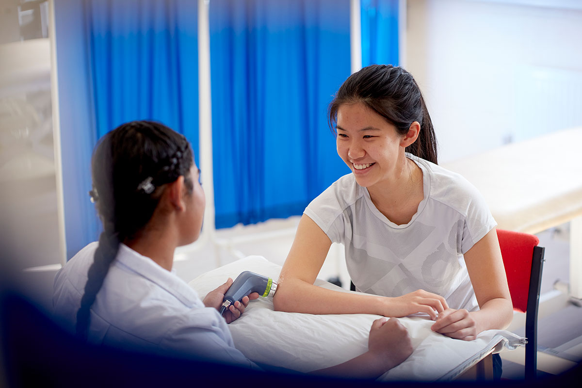 Physiotherapy student with a patient