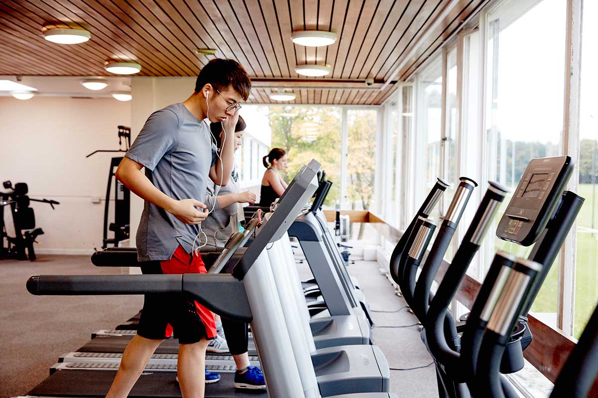 Student running on a treadmill in the gym