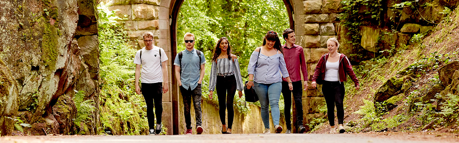 Students walking along a road on campus