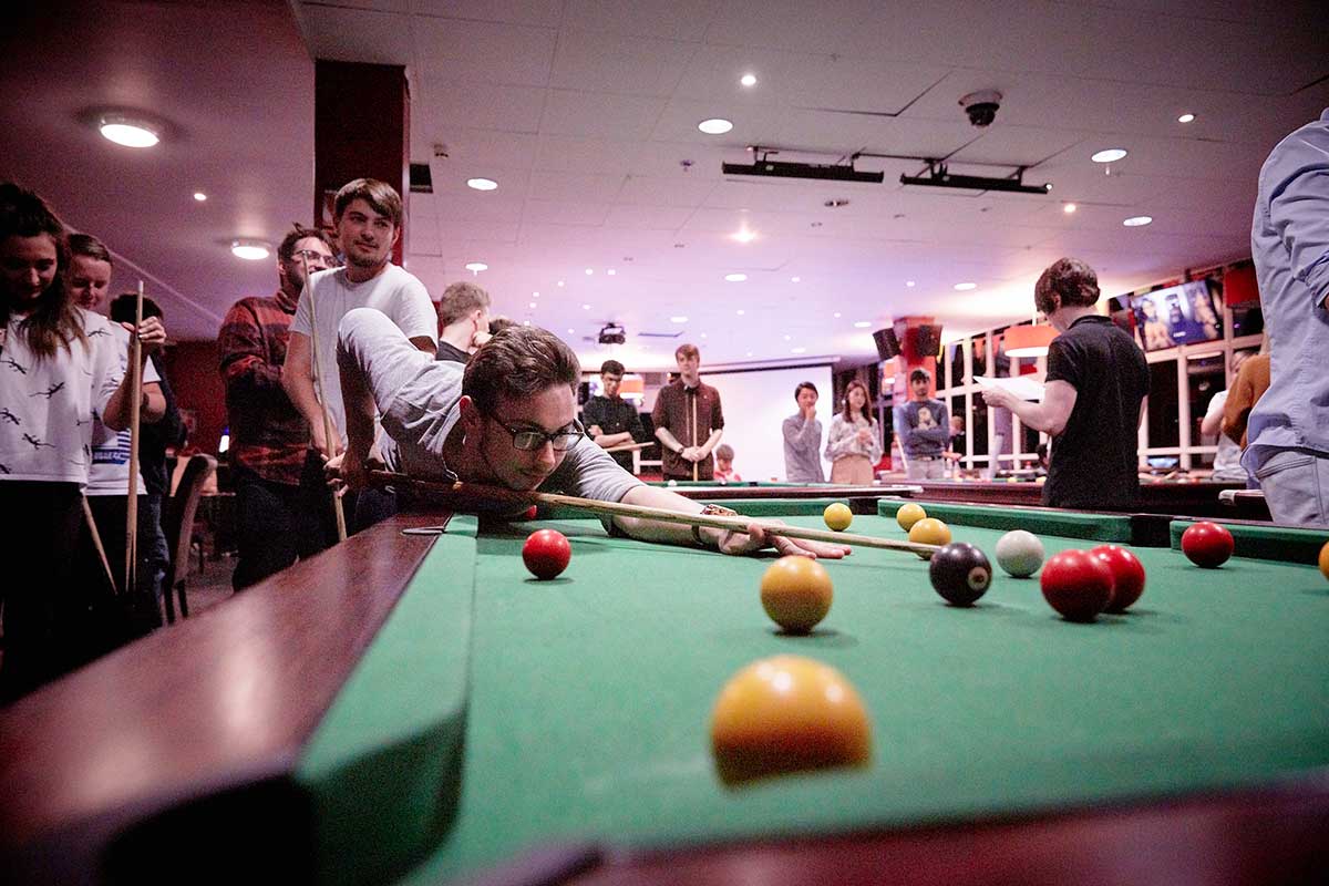 Student playing pool in students' union